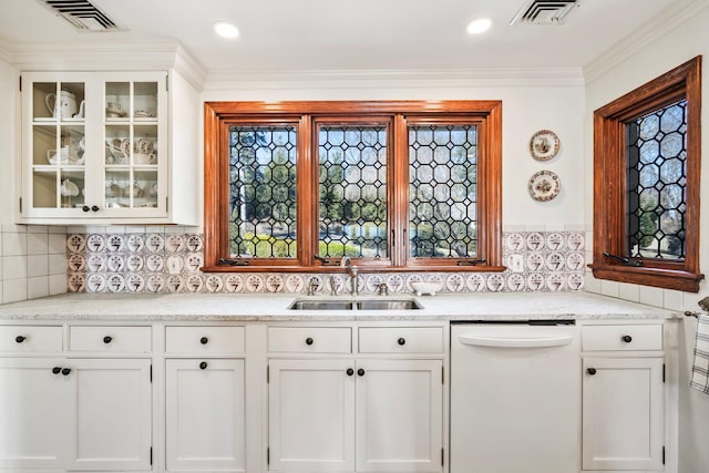 kitchen featuring white cabinetry, visible vents, white dishwasher, and a sink