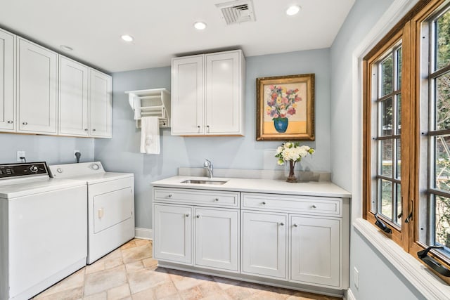 laundry area featuring visible vents, a sink, recessed lighting, cabinet space, and separate washer and dryer