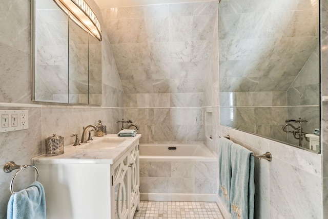 bathroom featuring tiled bath, tile walls, and vanity