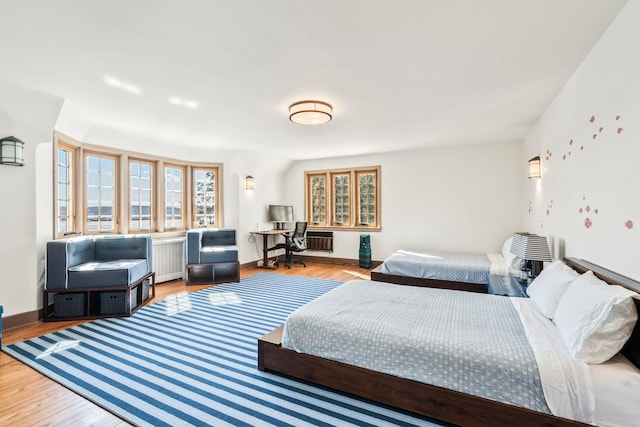 bedroom with light wood-style flooring and baseboards