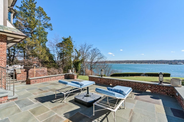 view of patio with a water view