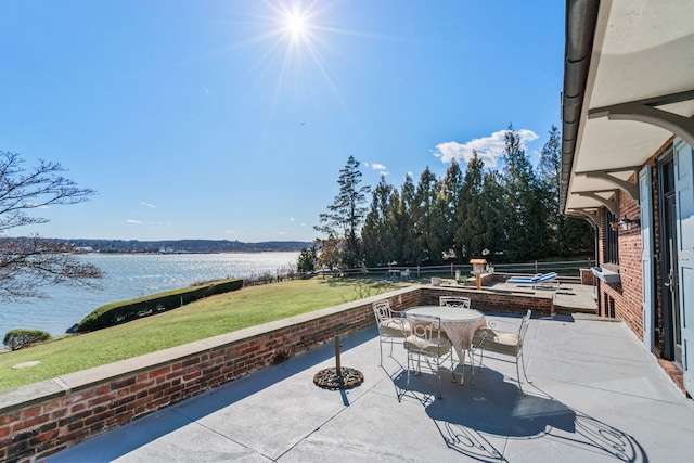 view of patio featuring outdoor dining area and a water view