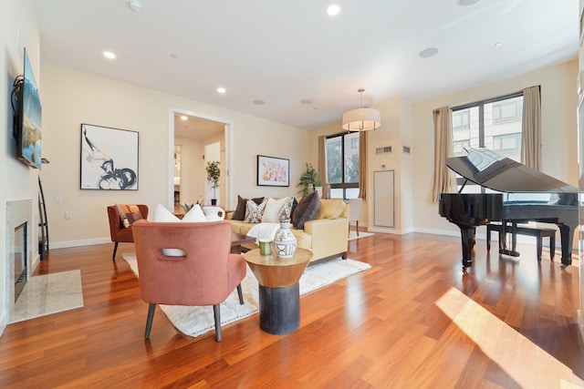 living room with recessed lighting, a healthy amount of sunlight, and wood finished floors