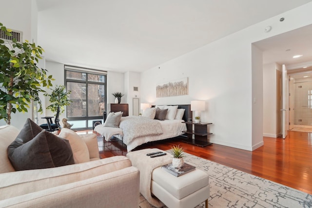 bedroom with wood finished floors and baseboards