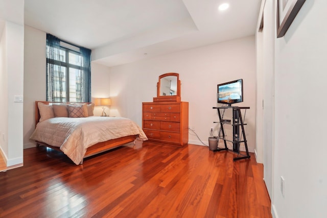 bedroom with baseboards and wood finished floors