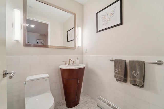 bathroom featuring a wainscoted wall, toilet, tile walls, and vanity