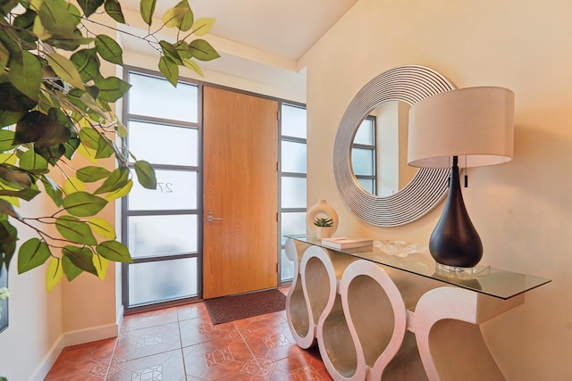 tiled entryway featuring baseboards