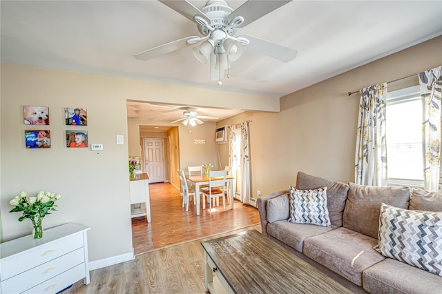 living room with ceiling fan, baseboards, and light wood-type flooring