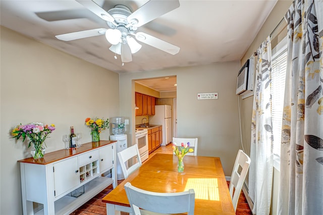dining space with light wood-type flooring and a ceiling fan