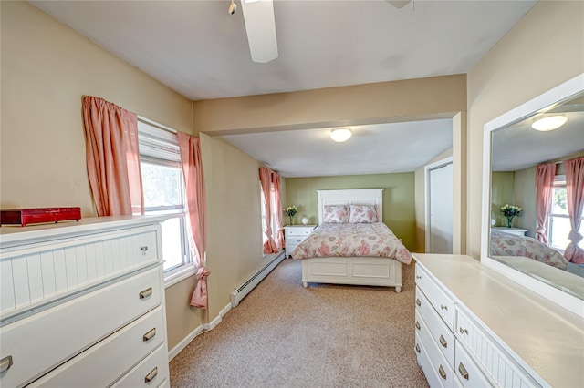 bedroom featuring a baseboard radiator, light carpet, and a ceiling fan