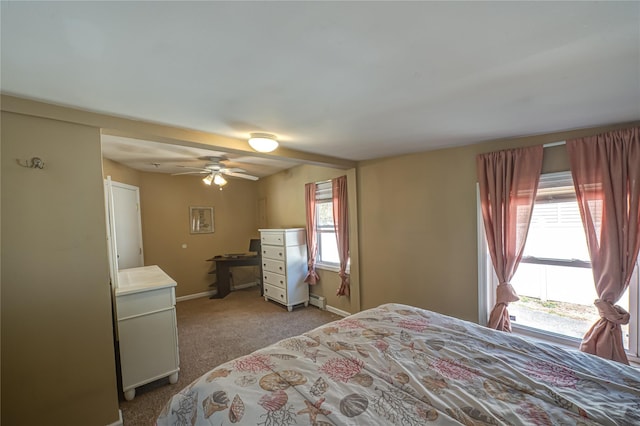 bedroom featuring light colored carpet, a baseboard radiator, baseboards, and a ceiling fan