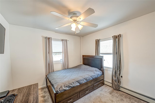 bedroom featuring ceiling fan, multiple windows, light carpet, and a baseboard heating unit