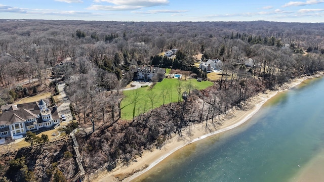 drone / aerial view with a beach view, a forest view, and a water view