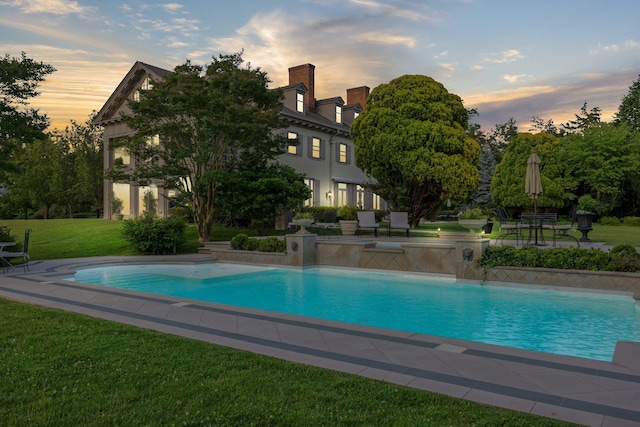 pool featuring a patio and a yard