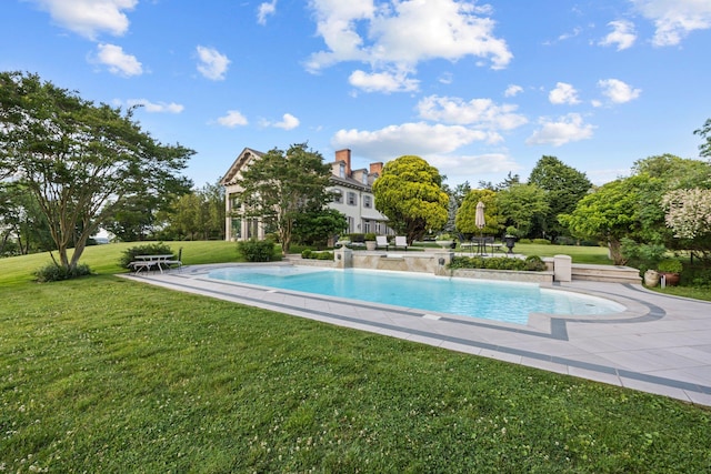 view of pool with a lawn