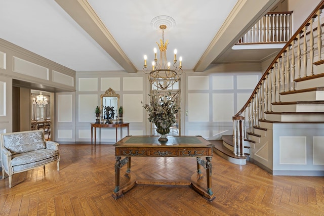 foyer entrance with a chandelier, a decorative wall, beamed ceiling, and stairway