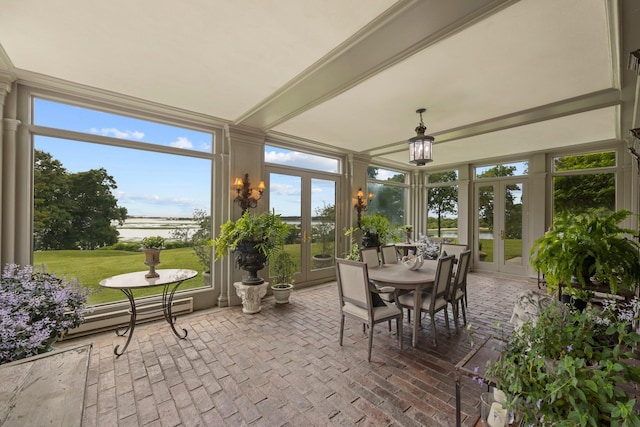 sunroom / solarium with a baseboard heating unit