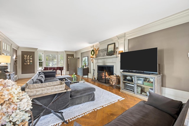 living area featuring a fireplace with flush hearth, baseboards, and ornamental molding