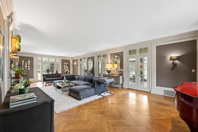 living area with visible vents, french doors, and baseboards