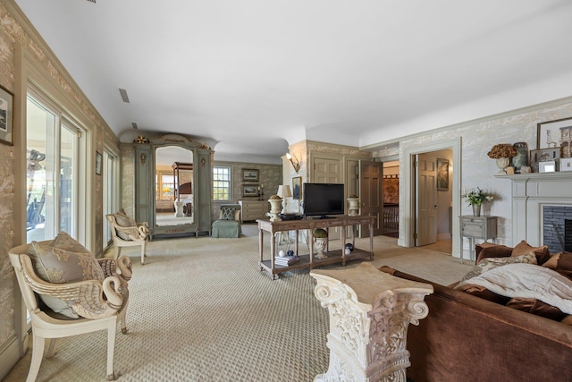 living area with a fireplace and light colored carpet