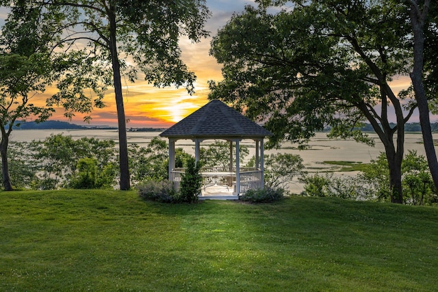 surrounding community with a gazebo and a yard