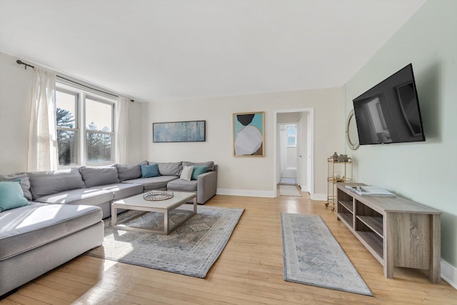 living room featuring light wood-type flooring and baseboards