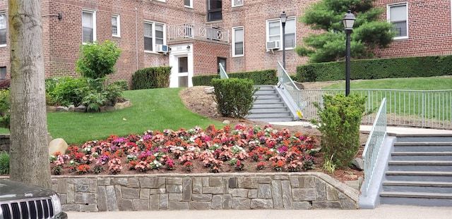 view of property's community featuring stairs and a yard