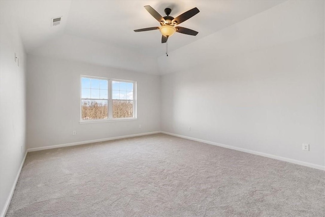 unfurnished room with visible vents, carpet floors, baseboards, and ceiling fan