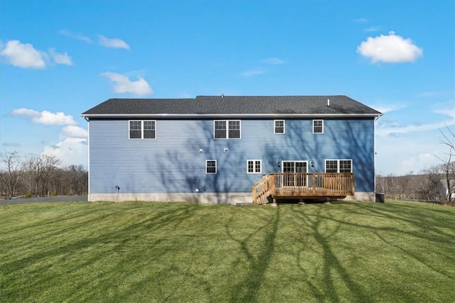 back of house with a lawn and a deck