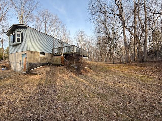 view of property exterior with a deck