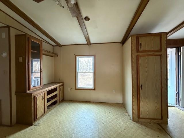 interior space with beamed ceiling and light floors