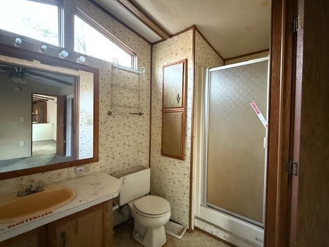 bathroom with a shower stall, wallpapered walls, toilet, and vanity