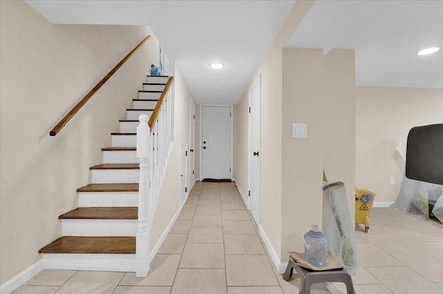 staircase featuring tile patterned floors, recessed lighting, and baseboards