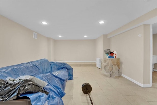 interior space with visible vents, recessed lighting, radiator heating unit, and baseboards