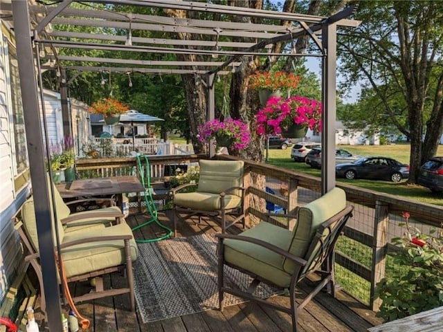 wooden deck with an outdoor living space and a pergola