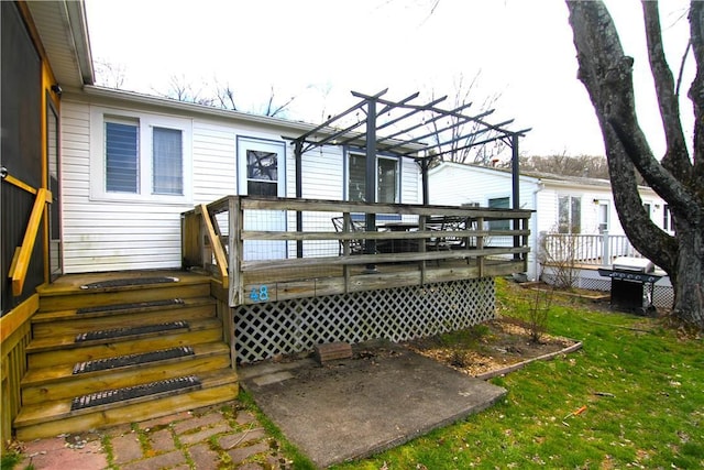 rear view of property featuring a wooden deck, a pergola, and a yard