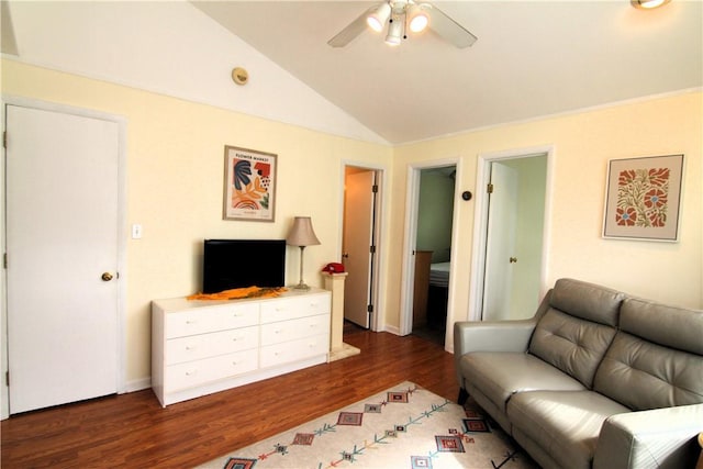 living room with wood finished floors, ceiling fan, and vaulted ceiling