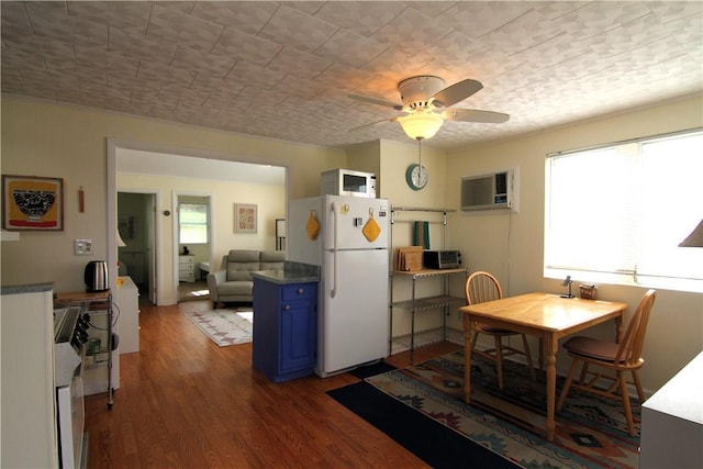 dining space featuring dark wood-style floors, a healthy amount of sunlight, a wall mounted air conditioner, and ceiling fan