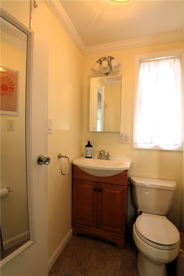 half bathroom featuring toilet, ornamental molding, tile patterned flooring, baseboards, and vanity