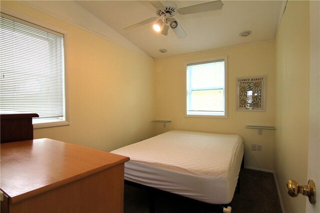 carpeted bedroom with ceiling fan and lofted ceiling