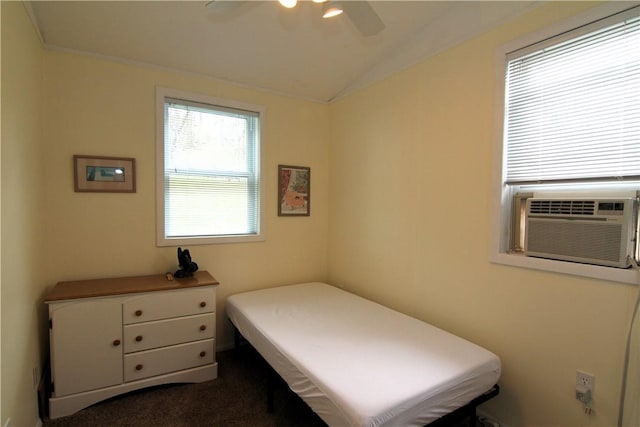 bedroom with vaulted ceiling, cooling unit, dark carpet, and ceiling fan