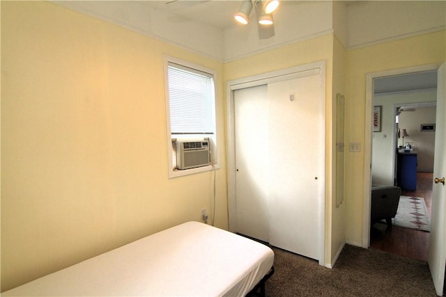 bedroom with a closet, cooling unit, a ceiling fan, and carpet floors