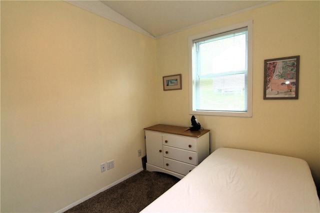 bedroom with vaulted ceiling, baseboards, dark carpet, and ornamental molding