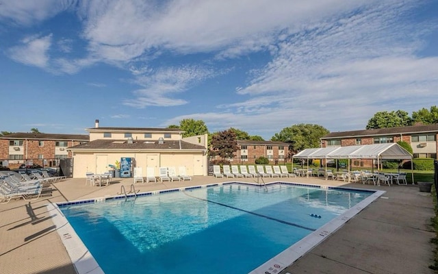 view of pool with a patio area and fence