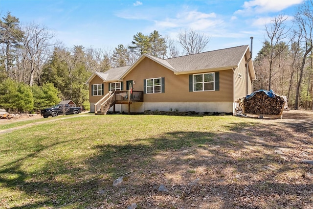 view of front of home featuring a shingled roof, stairs, a deck, and a front lawn