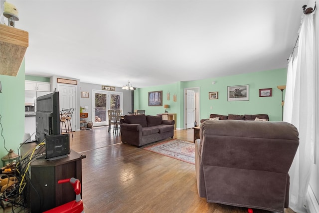 living room featuring an inviting chandelier and wood finished floors