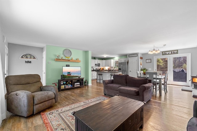 living room with an inviting chandelier and wood finished floors