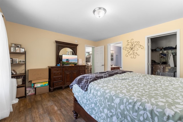bedroom with connected bathroom and dark wood finished floors