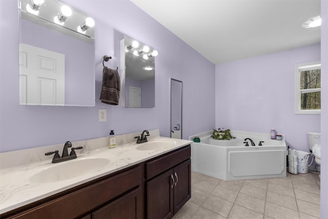full bath featuring a sink, a garden tub, toilet, and double vanity