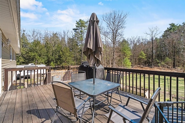 wooden deck featuring a yard and outdoor dining space